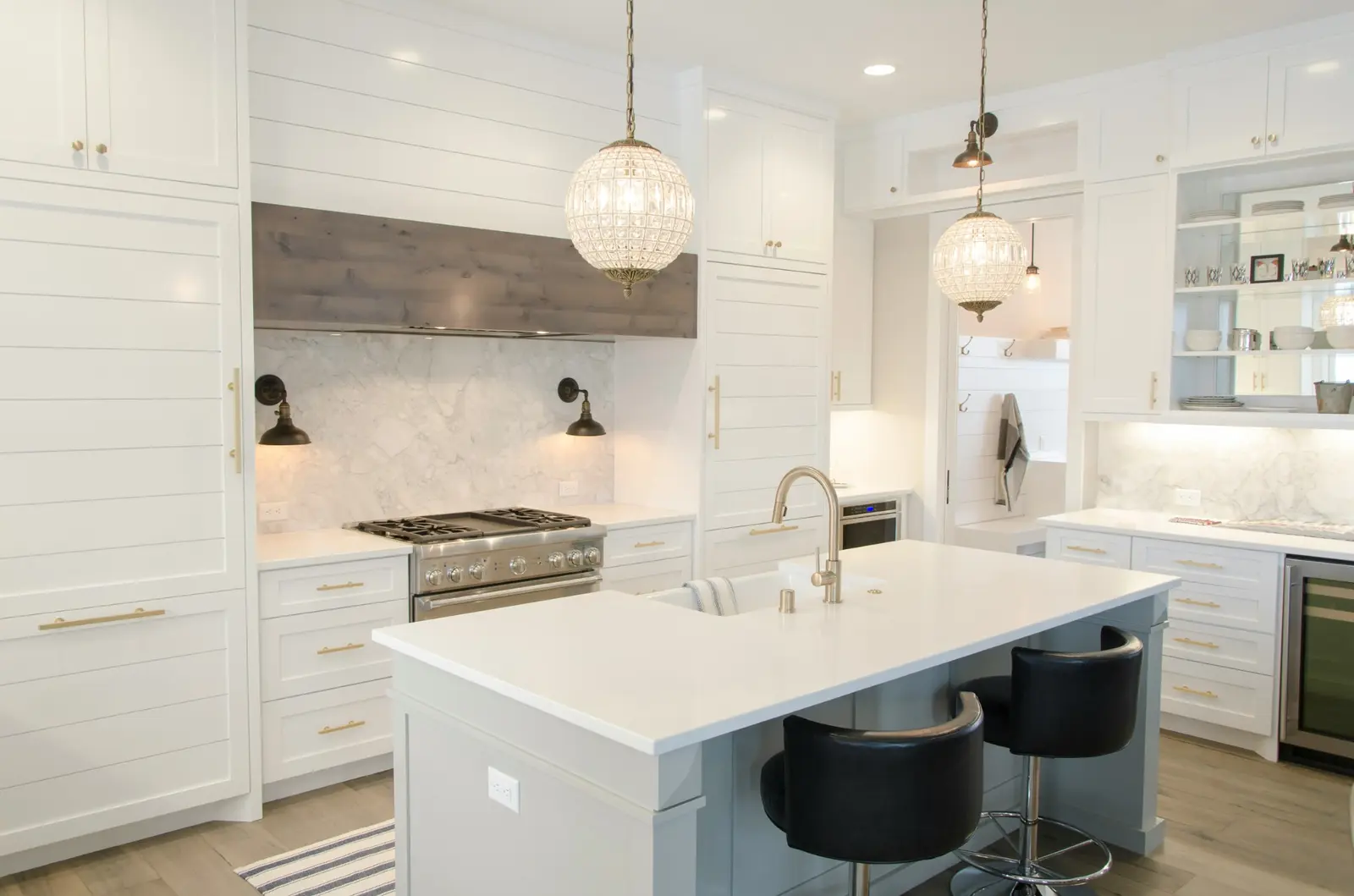 Transitional white kitchen with blue island
