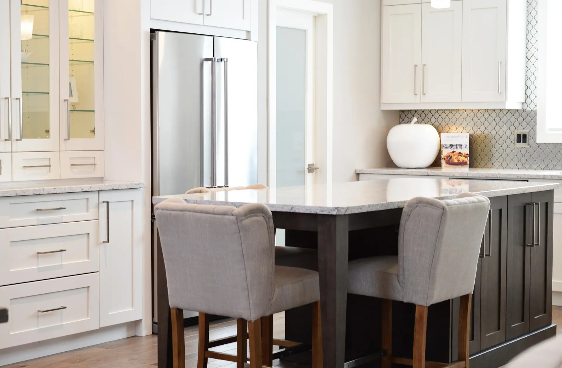 Bright kitchen with white and dark cabinetry around a central island